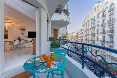 a balcony with a table with food on it at Palais Des Iles 2 by Halldis in Cannes