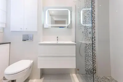 a bathroom with a toilet and a sink and a shower at Palais Des Iles 2 by Halldis in Cannes