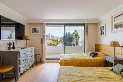 a bedroom with two beds and a window at REF 823 - Cannes Center - Duplex apartment for rent in Cannes