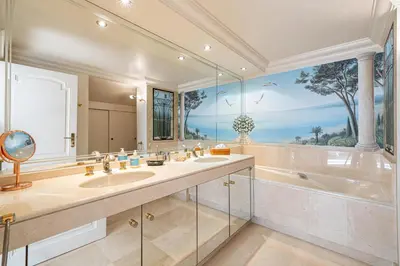 a bathroom with two sinks and a tub and a large window at REF 823 - Cannes Center - Duplex apartment for rent in Cannes