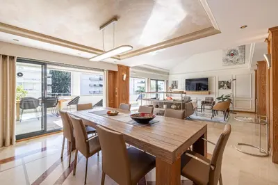 a dining room and living room with a wooden table and chairs at REF 823 - Cannes Center - Duplex apartment for rent in Cannes