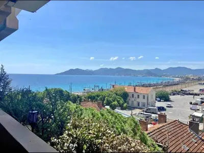 a view of a city with the ocean in the background at T2 Vue Mer à Cannes in Cannes