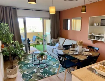 a living room with a table and a couch at T2 Vue Mer à Cannes in Cannes