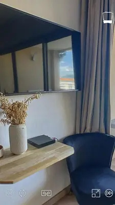 a blue chair sitting next to a desk with a window at T2 Vue Mer à Cannes in Cannes