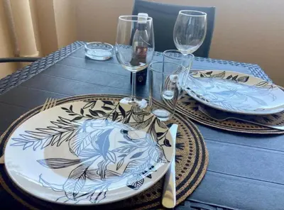 a table with glasses and a plate with a fish on it at T2 Vue Mer à Cannes in Cannes