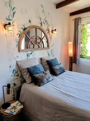a bedroom with a large white bed with pillows at Studio Suquet avec Parking in Cannes