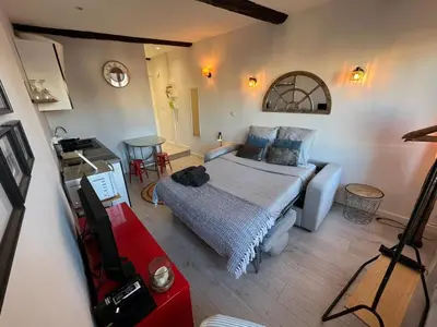 a bedroom with a bed and a table in a room at Studio Suquet avec Parking in Cannes