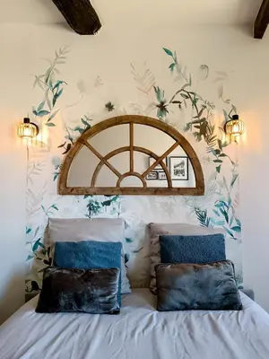 a bedroom with a bed with floral wallpaper at Studio Suquet avec Parking in Cannes