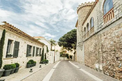 an empty street in a village with buildings at Studio Suquet avec Parking in Cannes