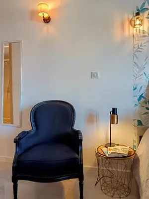 a blue chair in a room with a table at Studio Suquet avec Parking in Cannes