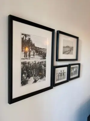 a group of framed pictures hanging on a wall at Studio Suquet avec Parking in Cannes