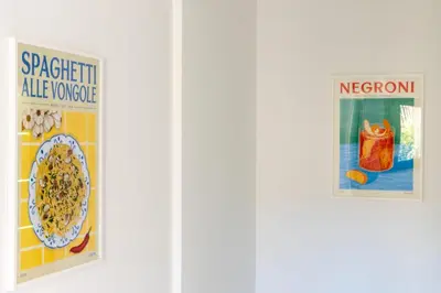 two posters on a wall with a bowl of cereal at Spacious 2-Br Apartment in a Residence with Pool in Cannes