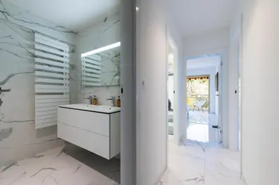 a white bathroom with a sink and a mirror at Spacious 2-Br Apartment in a Residence with Pool in Cannes
