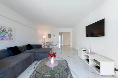 a living room with a couch and a table at Spacious 2-Br Apartment in a Residence with Pool in Cannes