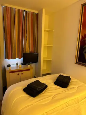 a bedroom with two black towels on a bed at Sisley 068 - F2 et magnifique vue mer in Cannes