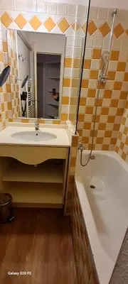 a bathroom with a sink and a tub and a mirror at Sisley 068 - F2 et magnifique vue mer in Cannes