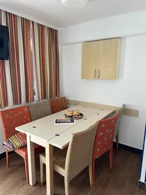 a room with a table and chairs and a couch at Sisley 068 - F2 et magnifique vue mer in Cannes
