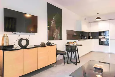 a living room with a large tv on the wall at BEAUTIFUL 1 - BR APARTMENT - Next To Rue Antibes in Cannes