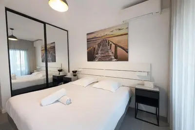 a bedroom with two beds and a painting on the wall at BEAUTIFUL 1 - BR APARTMENT - Next To Rue Antibes in Cannes