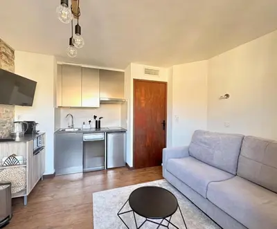a living room with a couch and a kitchen at Joséphines in Cannes