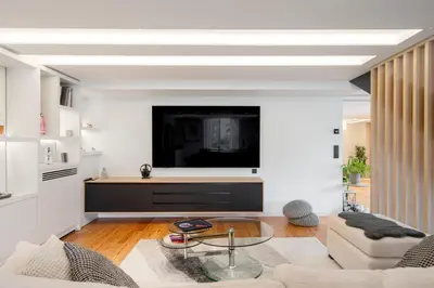 a living room with a flat screen tv on a wall at REF 1985 - Cannes - Duplex for rent in Cannes