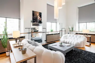 a living room with white furniture and large windows at REF 1985 - Cannes - Duplex for rent in Cannes