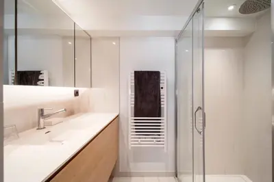 a white bathroom with a shower and a sink at REF 1985 - Cannes - Duplex for rent in Cannes