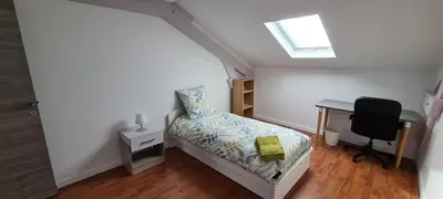 a bedroom with a bed and a desk and a chair at Villa Magenta in Cannes