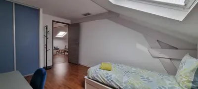 a attic bedroom with a bed and a staircase at Villa Magenta in Cannes