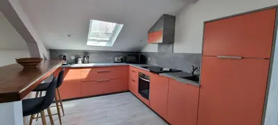 a kitchen with red cabinets and a wooden counter at Villa Magenta in Cannes