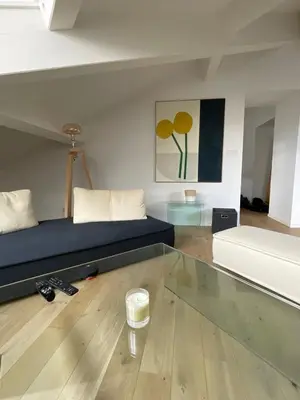 a living room with a couch and a bed at Beautiful modern apartment in Cannes in Cannes