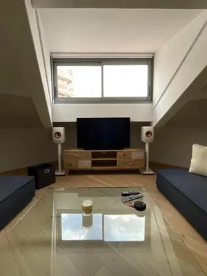 a living room with a tv and a glass table at Beautiful modern apartment in Cannes in Cannes