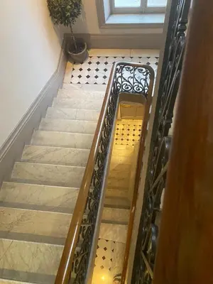 a set of stairs with a metal railing in a hallway at Beautiful modern apartment in Cannes in Cannes