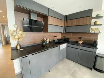 a kitchen with gray cabinets and a sink at Cannes centre-ville - Face mer 3 pièces avec terrasse in Cannes