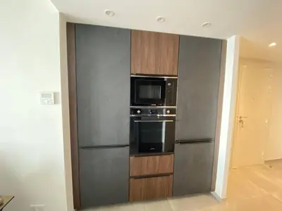 a kitchen with a stainless steel refrigerator and a microwave at Cannes centre-ville - Face mer 3 pièces avec terrasse in Cannes