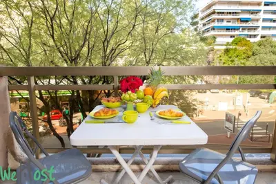 a white table with fruit and flowers on a balcony at Studio - Palais des Festivals in Cannes