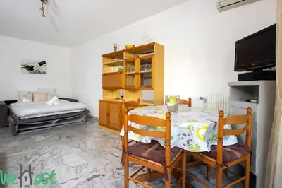 a room with a table and chairs and a bed at Studio - Palais des Festivals in Cannes