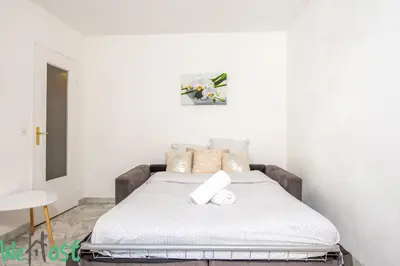 a bedroom with a bed with two towels on it at Studio - Palais des Festivals in Cannes