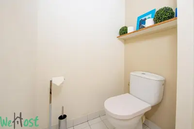a bathroom with a white toilet and a shelf at Studio - Palais des Festivals in Cannes