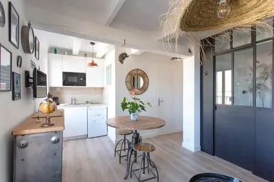 a kitchen with a small table and a counter at SAVANE -Studio cosy proche Croisette-Classé 2 Etoiles in Cannes