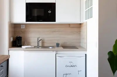 a kitchen with a sink and a microwave at SAVANE -Studio cosy proche Croisette-Classé 2 Etoiles in Cannes