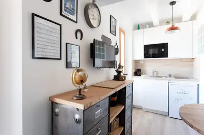 a kitchen with a desk and a counter top at SAVANE -Studio cosy proche Croisette-Classé 2 Etoiles in Cannes