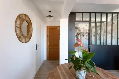 a room with a table and a mirror and a door at SAVANE -Studio cosy proche Croisette-Classé 2 Etoiles in Cannes