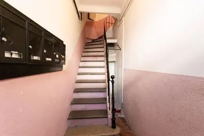 a staircase in a room with pink walls at SAVANE -Studio cosy proche Croisette-Classé 2 Etoiles in Cannes