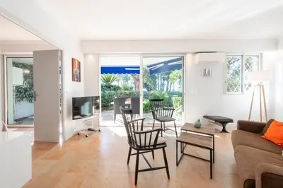 a living room with a couch and chairs at Garden level Croisette sea view with garage in Cannes