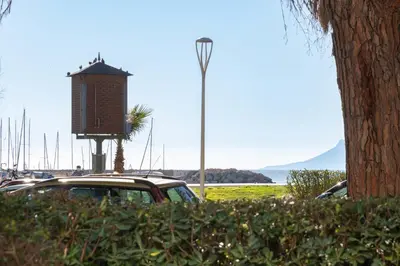 a car parked in a parking lot next to a tree at Garden level Croisette sea view with garage in Cannes