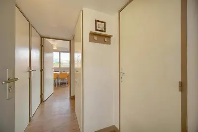 a hallway with white walls and wooden floors at Edouard - Piscine-Parking - VCA in Cannes