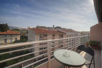 a balcony with a table and chairs on a balcony at Edouard - Piscine-Parking - VCA in Cannes