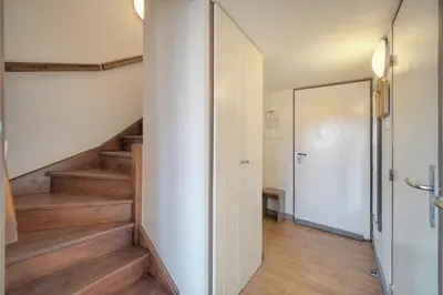 a hallway with wooden floors and stairs with a door at Edouard - Piscine-Parking - VCA in Cannes