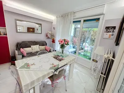 a living room with a table and a couch at Cosy 1 bedroom Republique 236 in Cannes